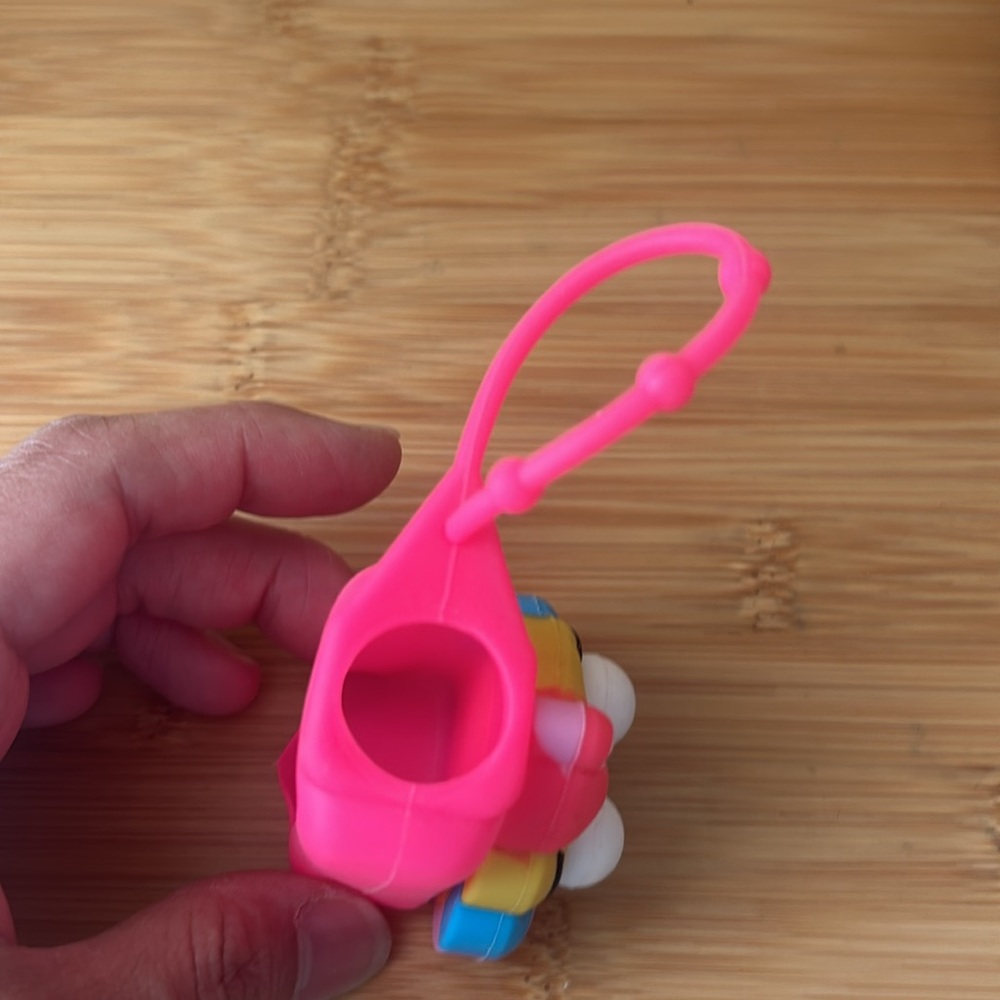 Colorful Smiling Poop Emoji hand sanitizer holder - Picture 4 of 4